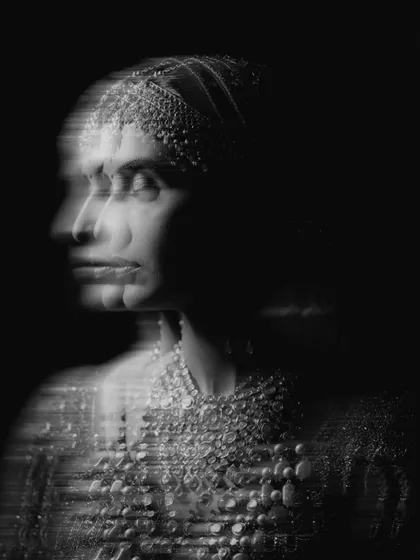 An artistic black and white bridal portrait that plays with motion and light. This creative, monochrome shot focuses on the bride's emotion and form, stripping away color to reveal a timeless and poetic image.