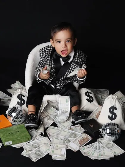 This 'Little Boss' theme is all about fun and attitude. Dressed in a sharp suit, this toddler is surrounded by playful money props, creating a hilarious and memorable kids portrait.