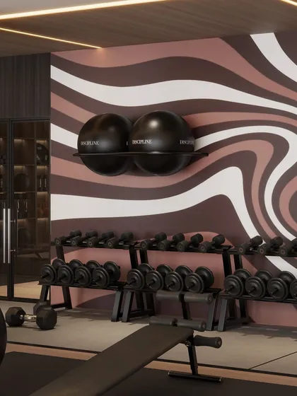 A close-up of the dumbbell rack and the wavy mural, highlighting the gym's unique design identity.