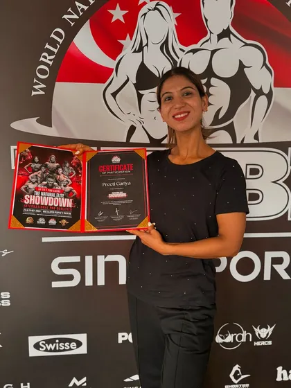 My client Preeti with her certificate at the WNBF Singapore event. Her hard work and dedication to her posing practice paid off on an international stage.