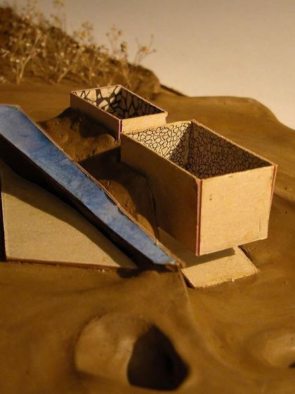 This part of the model shows the proposed intervention: simple, box-like structures that hover over the scarred landscape, creating spaces for reflection without erasing the past.