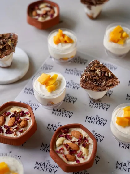 A delightful assortment of individual desserts, including creamy mango mousse, rich tiramisu, and traditional phirni. Every meal deserves a sweet ending, and I craft these single-serving treats to ensure every guest feels special.