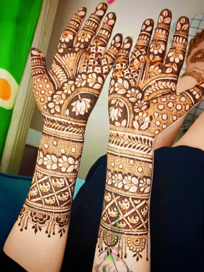 A beautiful full-hand design with lotus motifs and intricate bands of flowers and checks.