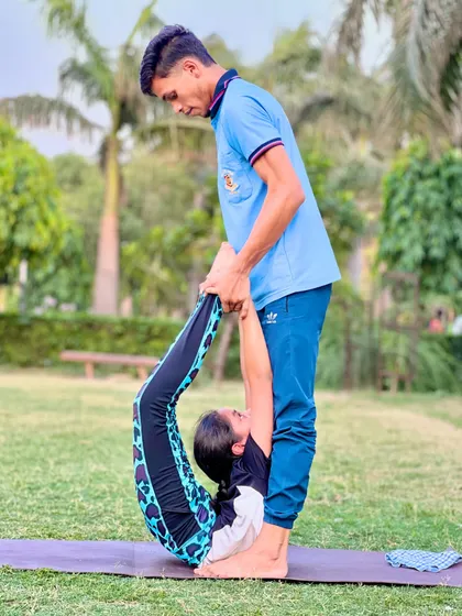 Here I am assisting a student to deepen her backbend. This kind of partner adjustment is a key part of my teaching method.