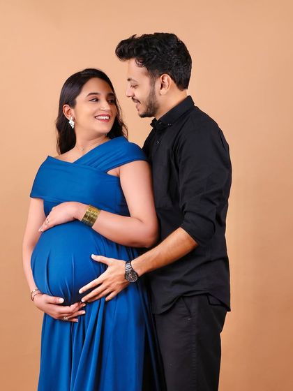 A classic pose for expecting parents. The shared look and gentle hold on the baby bump create a timeless and romantic portrait that you will cherish forever.