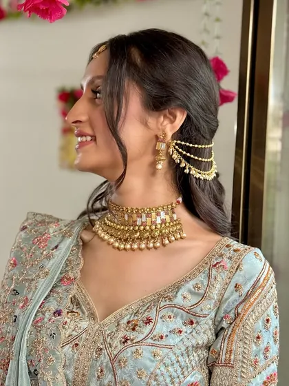 A side profile highlighting the unique earpiece and the soft, romantic hairstyle.