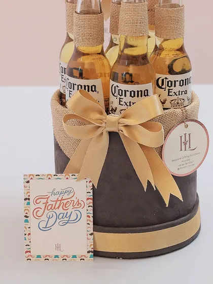 A close-up of the Corona beer hamper, showing the burlap-wrapped bottles and the "Happy Father's Day" card. It's a simple, stylish, and dad-approved gift.