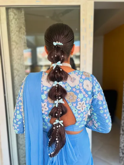 Who says bridal hair can't be playful? This is my take on a desi Jasmine look, featuring a bubble braid decorated with delicate pearls and cute pastel blue bows. It’s a fun, modern hairstyle perfect for a Mehendi or Haldi function.