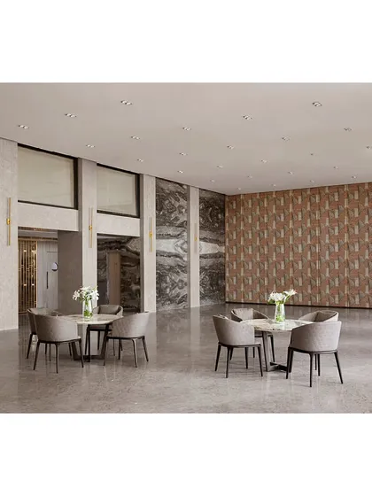 The spacious banquet hall features a neutral color palette, allowing it to be adapted for various events, with a feature wall of textured fabric adding visual interest.