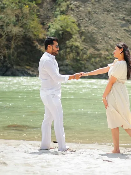 A classic romantic pose on the banks of the Ganga, with the couple holding hands and ready to walk together.