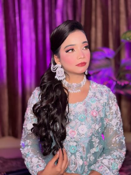 A side profile of Aira's soft glam makeup. This angle highlights the winged eyeliner and the beautiful blend of colors on her cheeks and eyes, creating a very polished look.