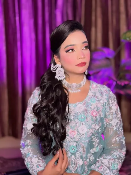 A side profile of Aira's soft glam makeup. This angle highlights the winged eyeliner and the beautiful blend of colors on her cheeks and eyes, creating a very polished look.