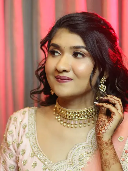 Contouring dreams into reality. This bride's reception look is all about modern glamour, with defined features, shimmery eyes, and a beautiful pastel lehenga.