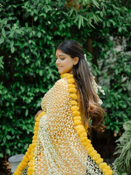 A unique floral dupatta for this bride's Haldi ceremony. The hairstyle is kept simple with a gajra to complement the look.