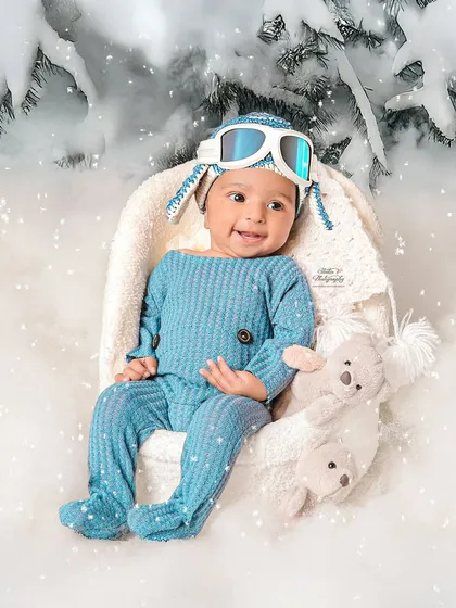 Look at that smile. This sitter session captures the pure joy of a baby who has just discovered the fun of sitting up. I created this winter wonderland theme right in my Rohtak studio to give this little explorer a magical, snowy backdrop for his portrait.