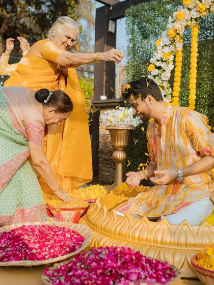 The elders of the family shower the groom with blessings and flower petals. A beautiful moment that shows the importance of family traditions and love.
