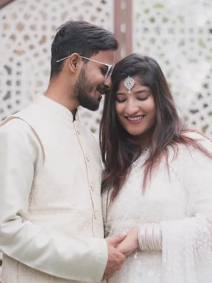 A sweet and happy portrait of an engaged couple. The bride's shy smile and the groom's gentle lean-in create a picture of pure, simple love.