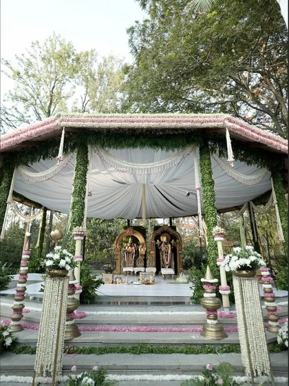 For this wedding, we constructed a divine space right in the middle of nature. The mandap was designed to feel like a serene temple, complete with idols and traditional floral arrangements, blending spirituality with natural beauty.