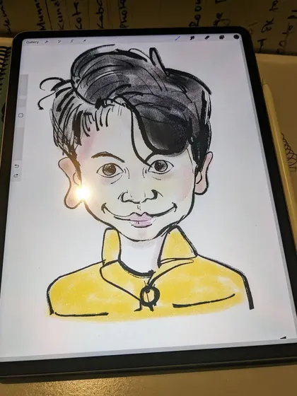 The digital caricature being drawn on a tablet. This shows that we embrace both traditional and modern art-making tools.