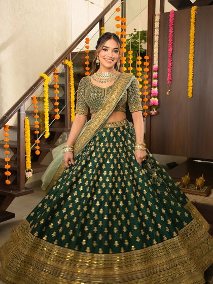 Serving festive elegance with a side of glow. This look in a stunning green lehenga is all about radiant skin, softly sculpted features, and a perfect blend of tradition and trend.