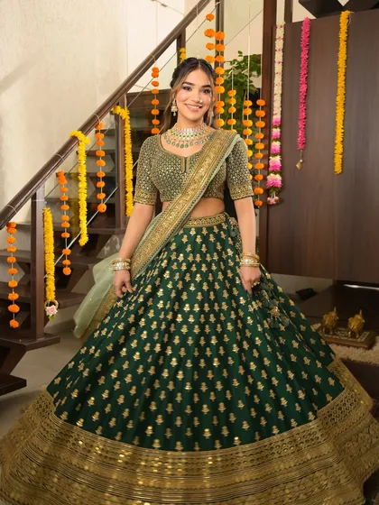 Serving festive elegance with a side of glow. This look in a stunning green lehenga is all about radiant skin, softly sculpted features, and a perfect blend of tradition and trend.