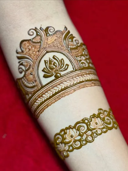 The design begins to take shape as I add a delicate floral band below the main lotus motif.