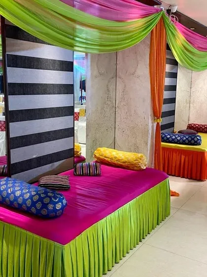 Traditional low seating arrangements for a Mehendi or Sangeet function. We use colorful mattresses and bolsters with bright fabric drapes to create a comfortable and festive lounge area for guests.