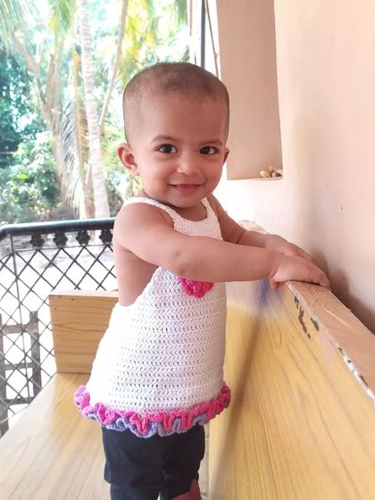 The side view of this white summer top shows its open-back design, which makes it extra breathable for hot days.