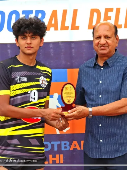 One of my players receives the "Best Player of the Match" award from a Football Delhi official after an outstanding performance in a B Division league game.