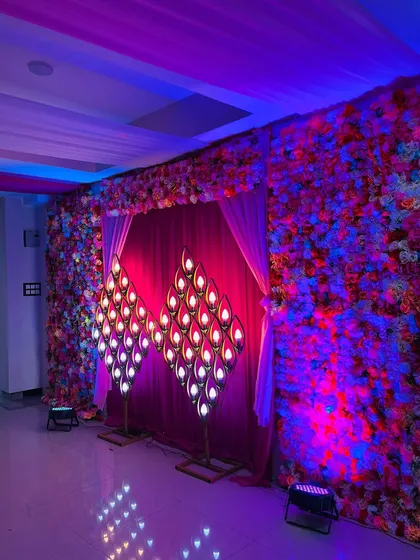 The stage decor seen with dramatic blue and pink lighting. I use lighting to enhance the decorations and set the mood for the party.
