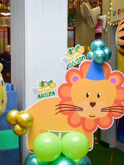A cute lion cutout adds a friendly roar to our jungle-themed party decor.