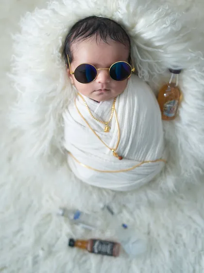 Presenting 'Dubai ka Anna'. This fun, stylized shoot with gold chains and sunglasses is a playful take on a cool, boss-like persona for a baby.