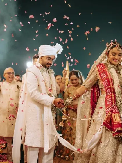 The couple takes their first steps as husband and wife during the pheras, surrounded by the love and blessings of their family.