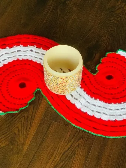 This spiral Christmas table runner in red and white is a unique statement piece for a dining table or console.