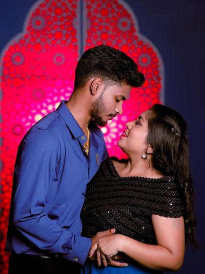 An intimate close-up shot. The focus is on their connection, and their simple outfits complement the mood perfectly.