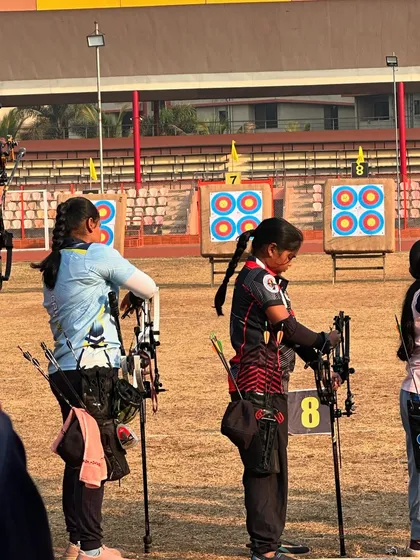 Young competitors wait for their turn on the shooting line, learning the rules and etiquette of competitive archery.