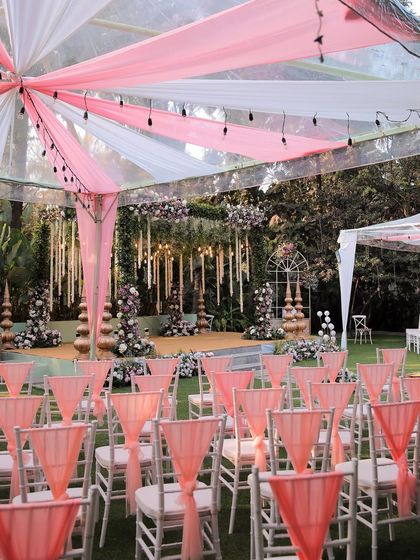 A collection of stunning wedding setups at The Farmhouse Collective. You can see the venue's versatility, from elegant morning ceremonies with floral mandaps to glamorous evening receptions with fairy lights and chic decor. This space is a blank canvas for your dream outdoor wedding in Bengaluru.