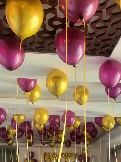 Another angle of the purple and gold helium balloon ceiling decoration.