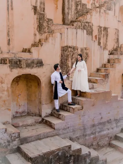 Our pre-wedding shoots are about telling your story in a beautiful setting. This candid moment, captured at a historic step-well, shows our approach to creating natural, romantic images that reflect your personality against a stunning architectural backdrop.
