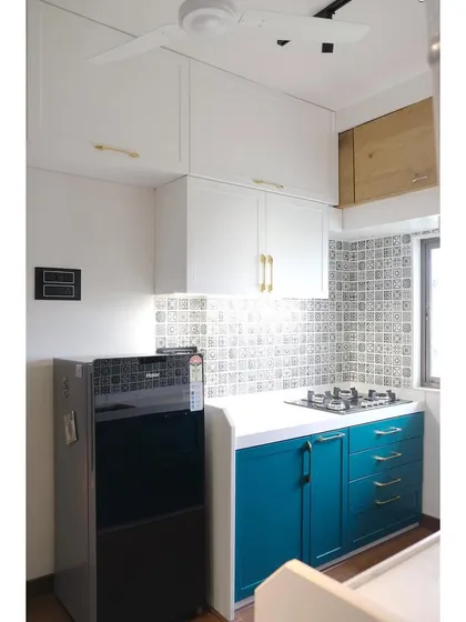 We were honored to design this kitchen for social media influencers Abhi and Niyu. The project features a beautiful combination of teal and white PU finish cabinets with shaker-style doors and elegant gold handles.
