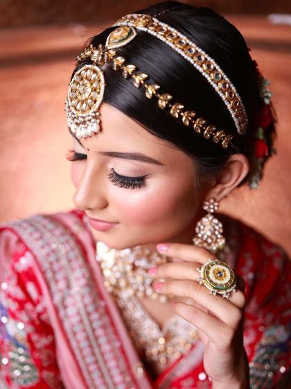 A focus on the intricate details. The sharp winged liner, voluminous lashes, and the traditional matha patti come together to create a look that is both classic and striking.