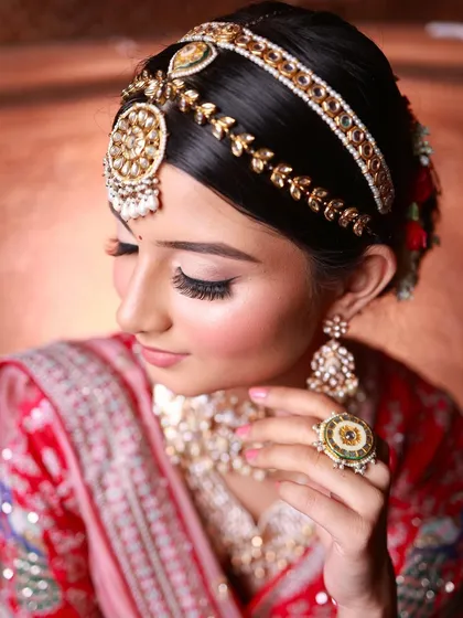 A focus on the intricate details. The sharp winged liner, voluminous lashes, and the traditional matha patti come together to create a look that is both classic and striking.