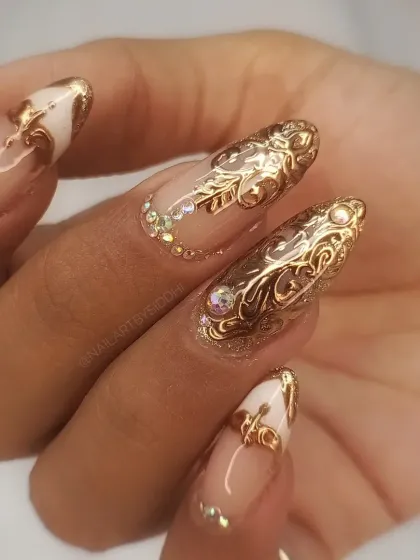 A high-quality, professional shot showcasing the intricate 3D gold filigree and crystal nail art.