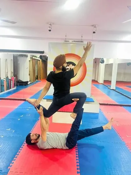 This is a playful acro yoga pose where the base supports the flyer in a seated position. It's a great way to build confidence and learn the fundamentals of balancing on a partner.