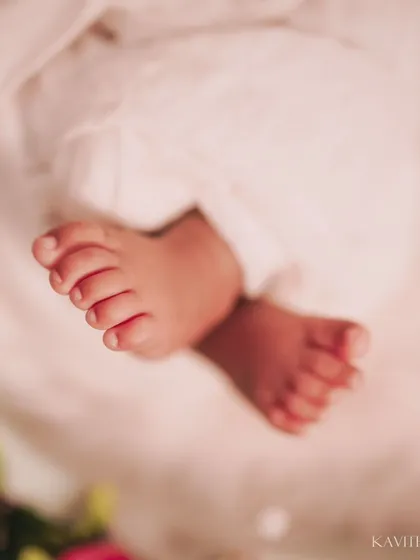 Tiny toes against a soft pink floral background. This macro shot is all about capturing the delicate and precious nature of a newborn's feet.