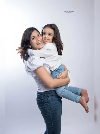 A big hug for mom! This photo radiates pure love and the special bond between a mother and her daughter.