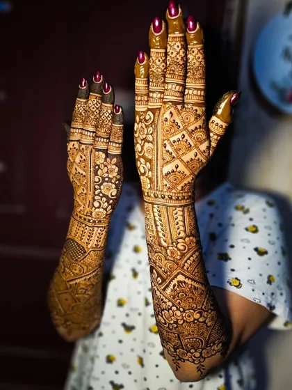 Another angle of the dense bridal henna, showing the detailed work on the fingers and palms.