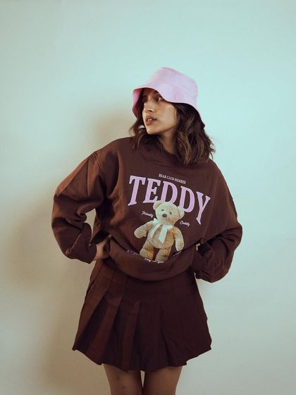 A confident pose from the same 'Teddy' series with Diksha Rawat. This shot highlights the casual, trendy styling of the outfit.