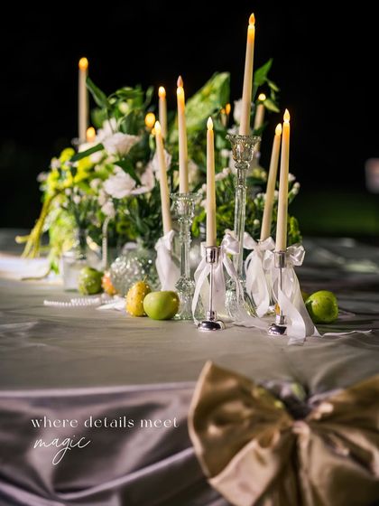 A close-up of the candlelit tablescape, with the text overlay "where details meet magic".