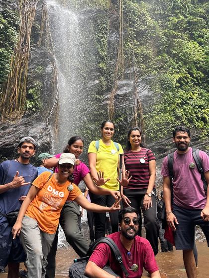 A group of friends posing at Hidlumane Falls, a highlight of the Kodachadri trek.